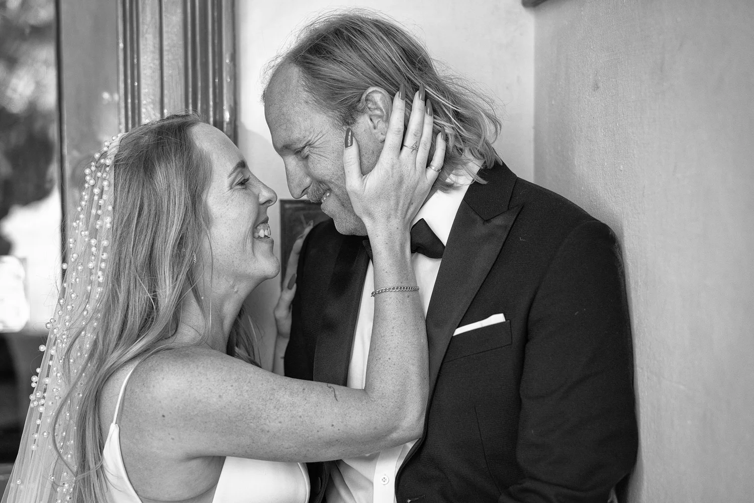 Black and white photo of Latham holding Chanel's face