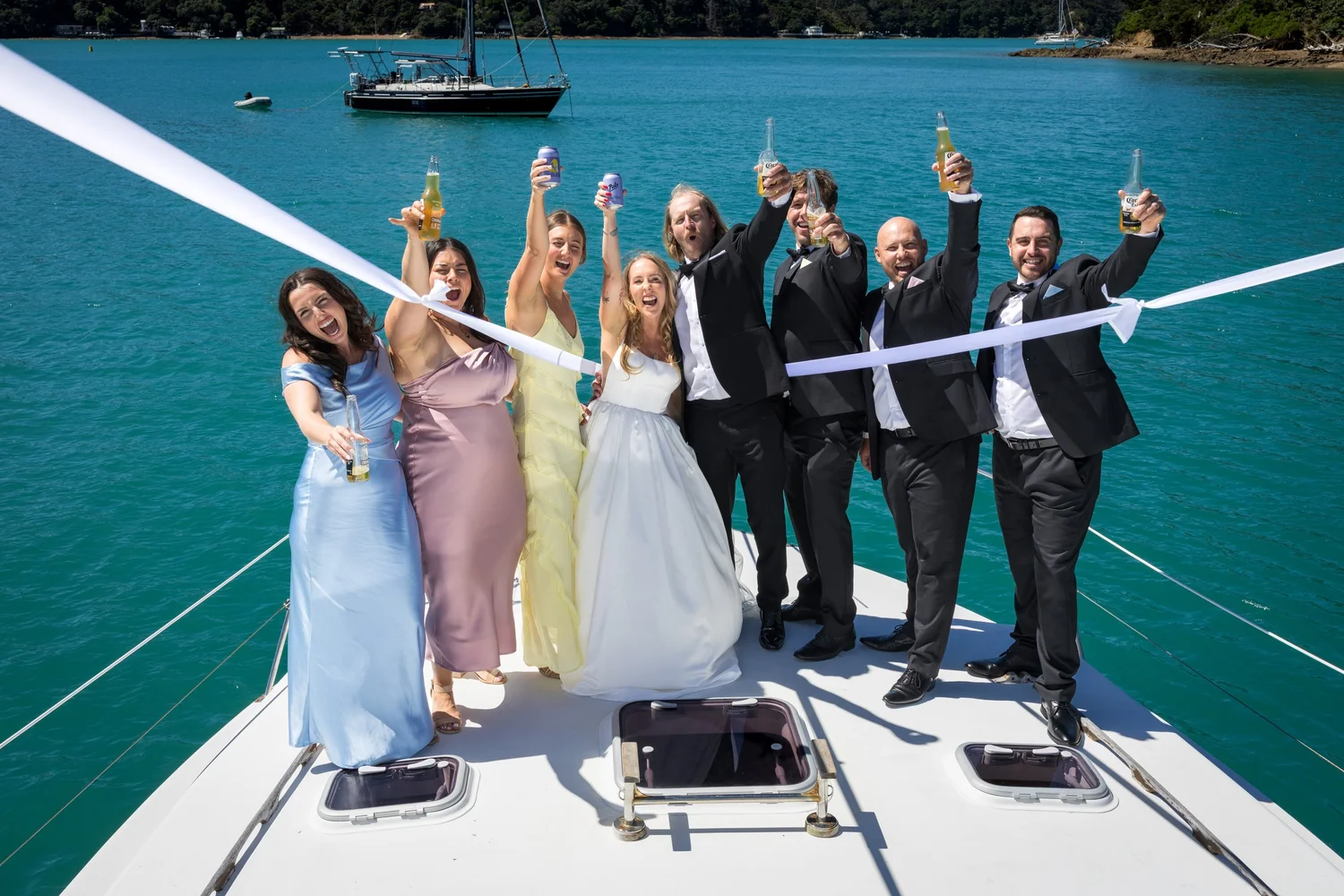 The bridal party cheers on the deck of a boat to Kawau Island