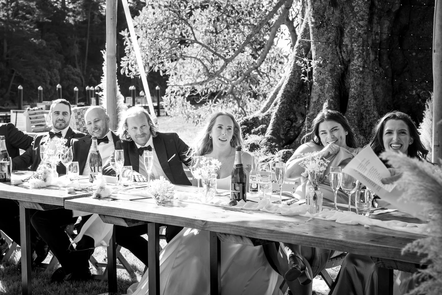 Black and white photo of guests at the long reception table