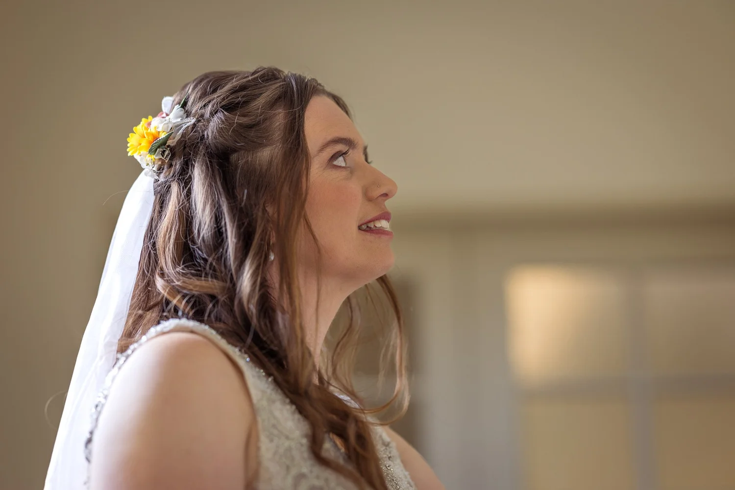 Mikaela with a flower in her hair looking away