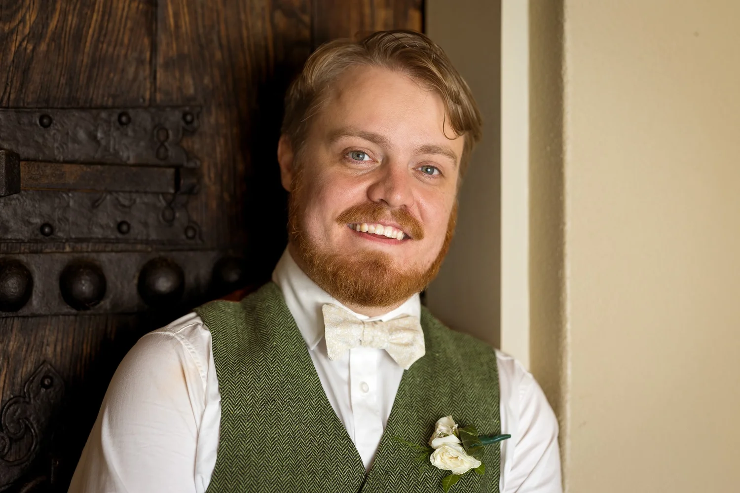 Dylan smiles in his green waistcoat and bow tie