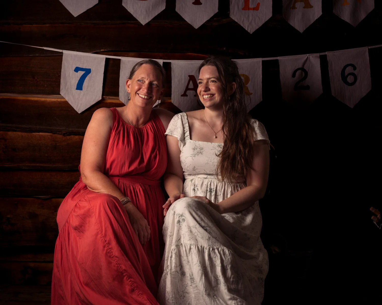Mikaela with a guest in red seated for a portrait