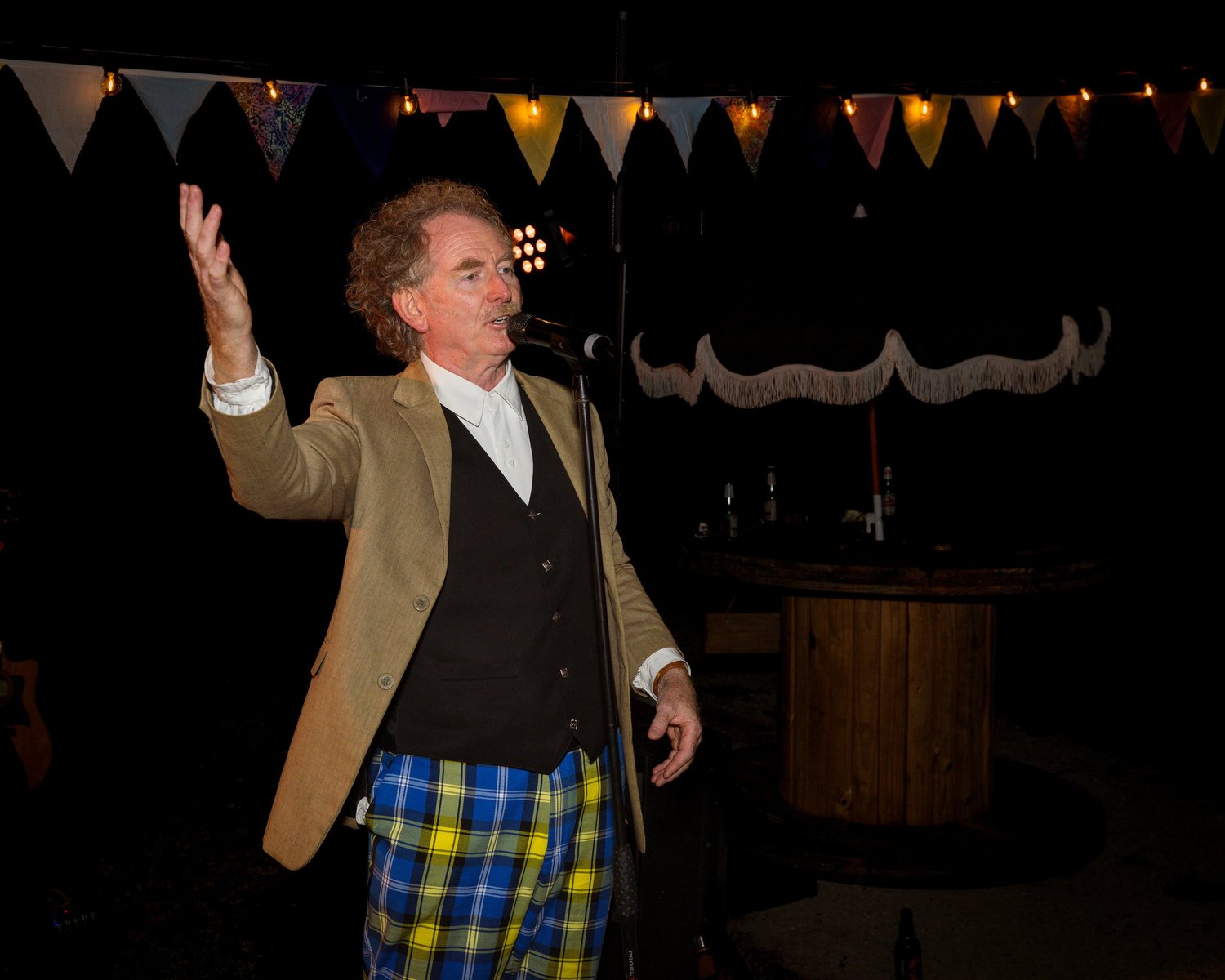 A guest in a tartan kilt gives a speech