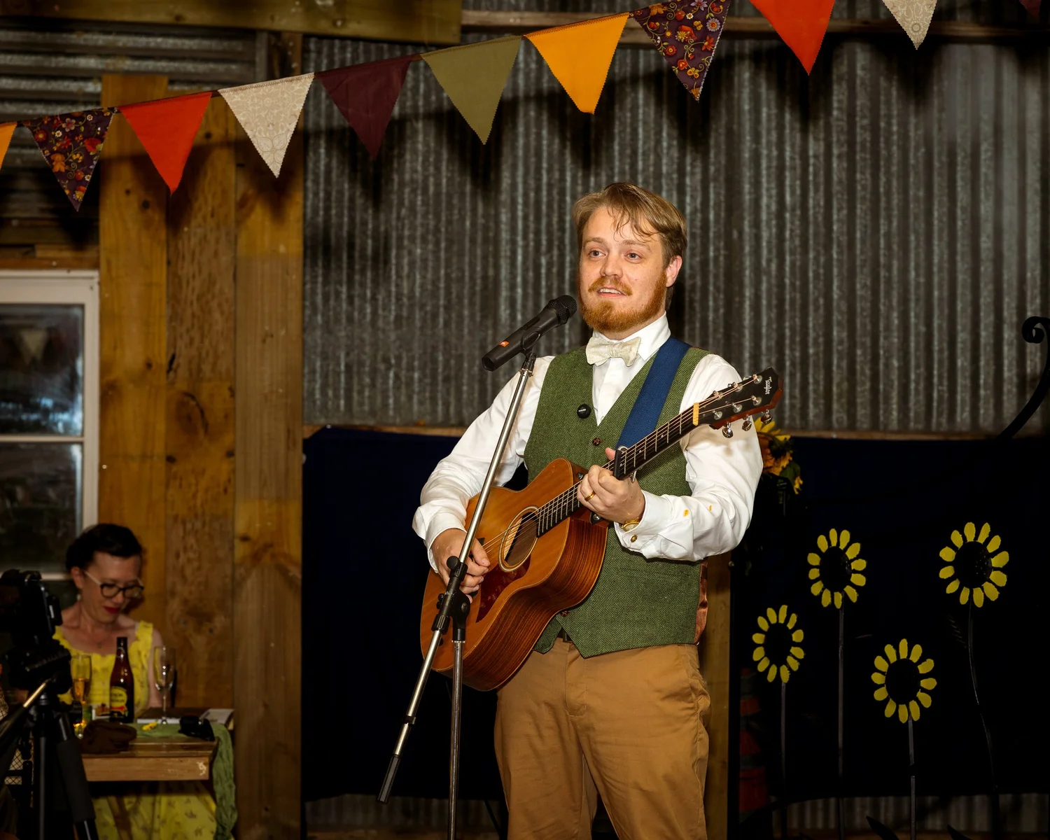 Dylan sings and plays guitar in the barn