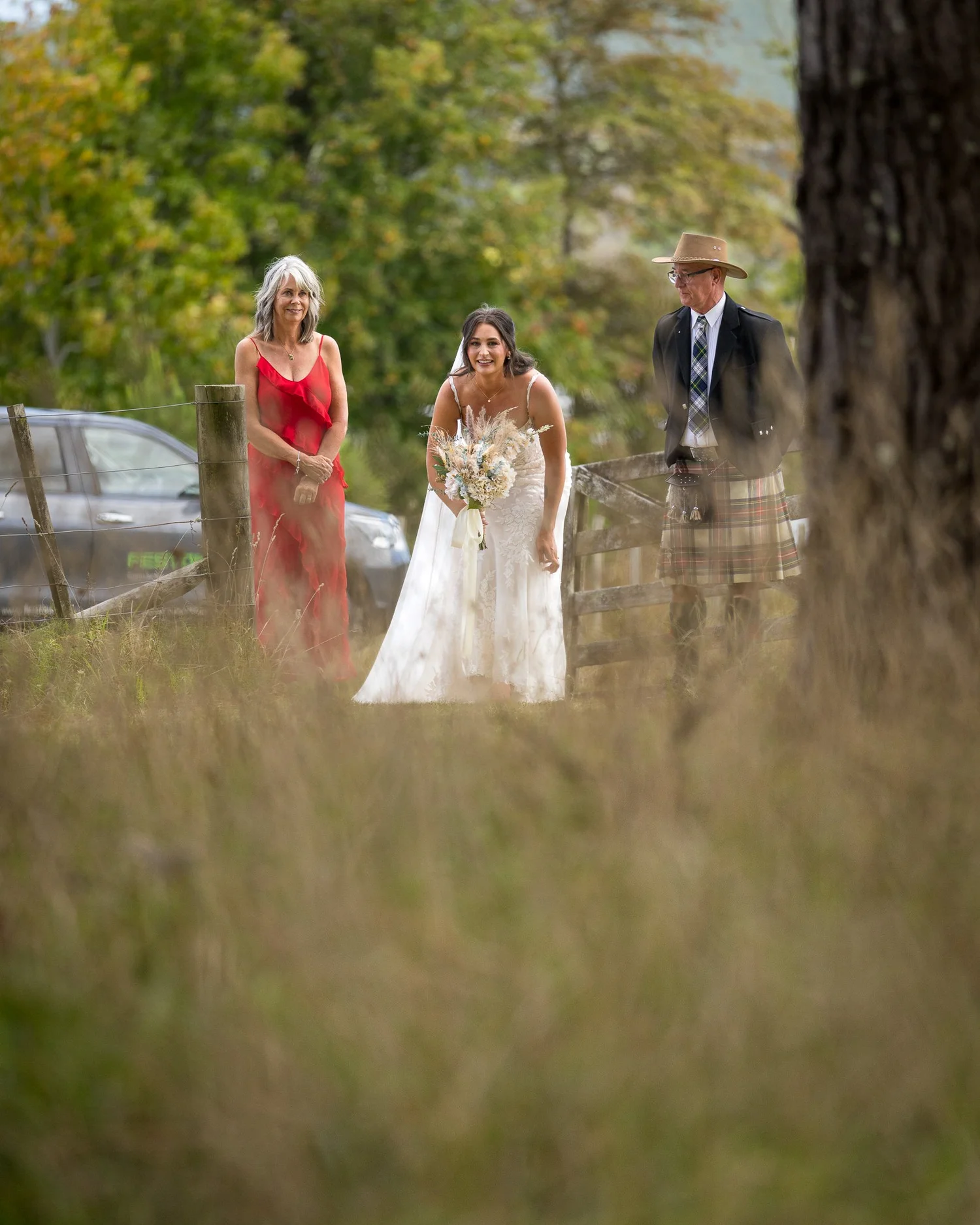 Tay arrives with her parents through the long grass