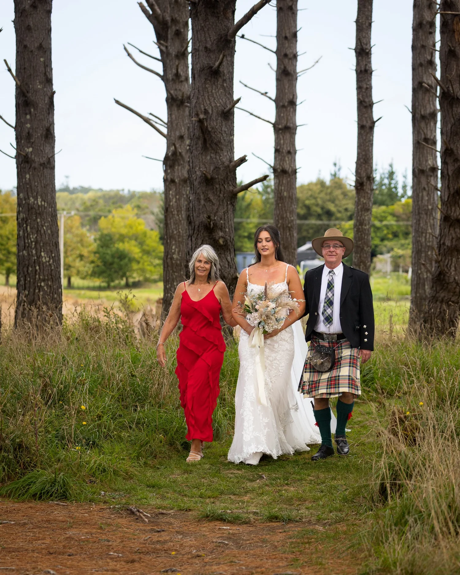Tay is walked down the aisle by her parents
