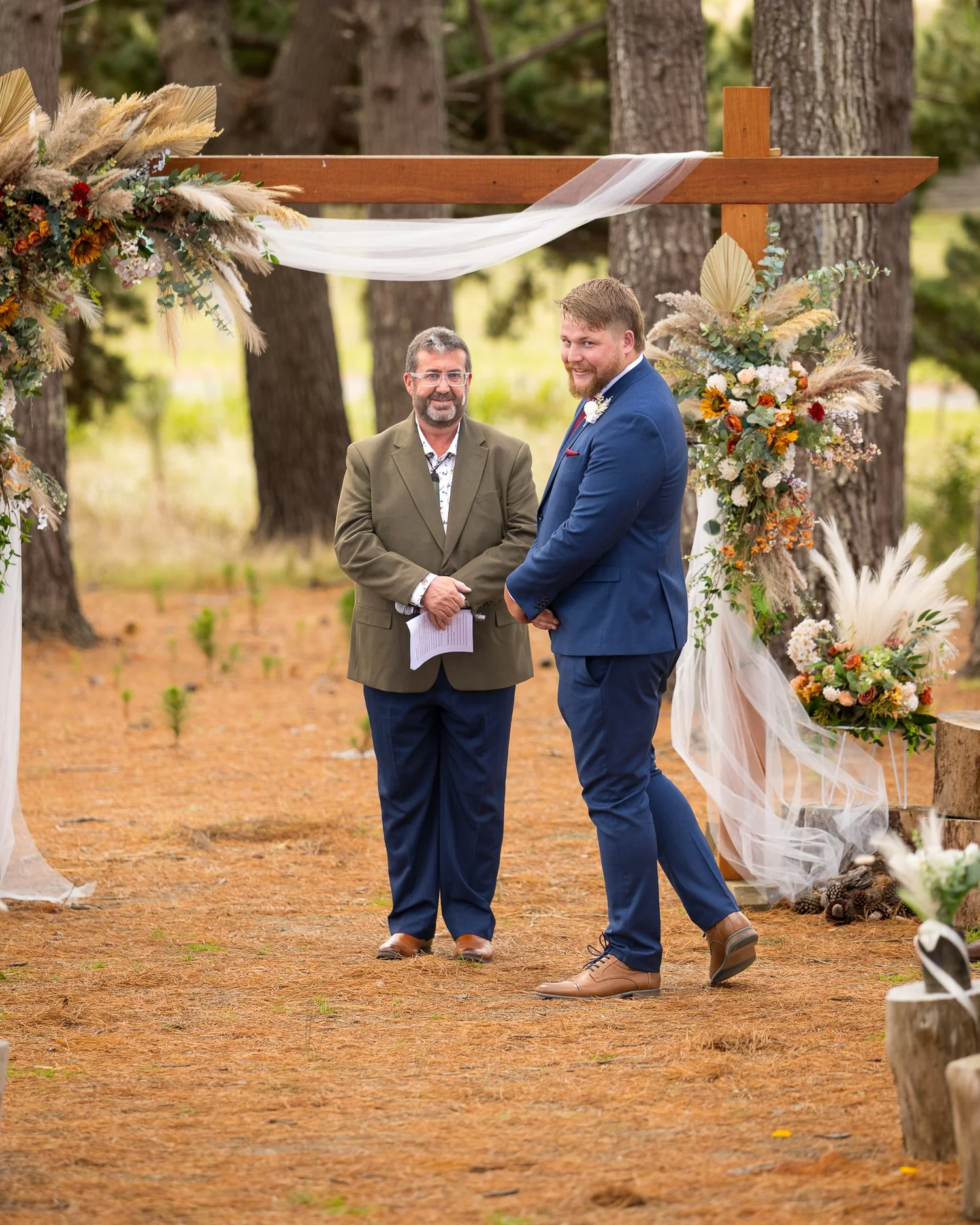 Jesse waits with the celebrant under the arch