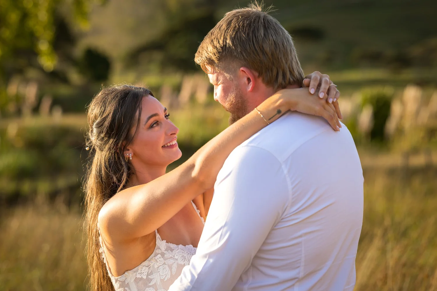 Tay wraps her arms around Jesse in golden light