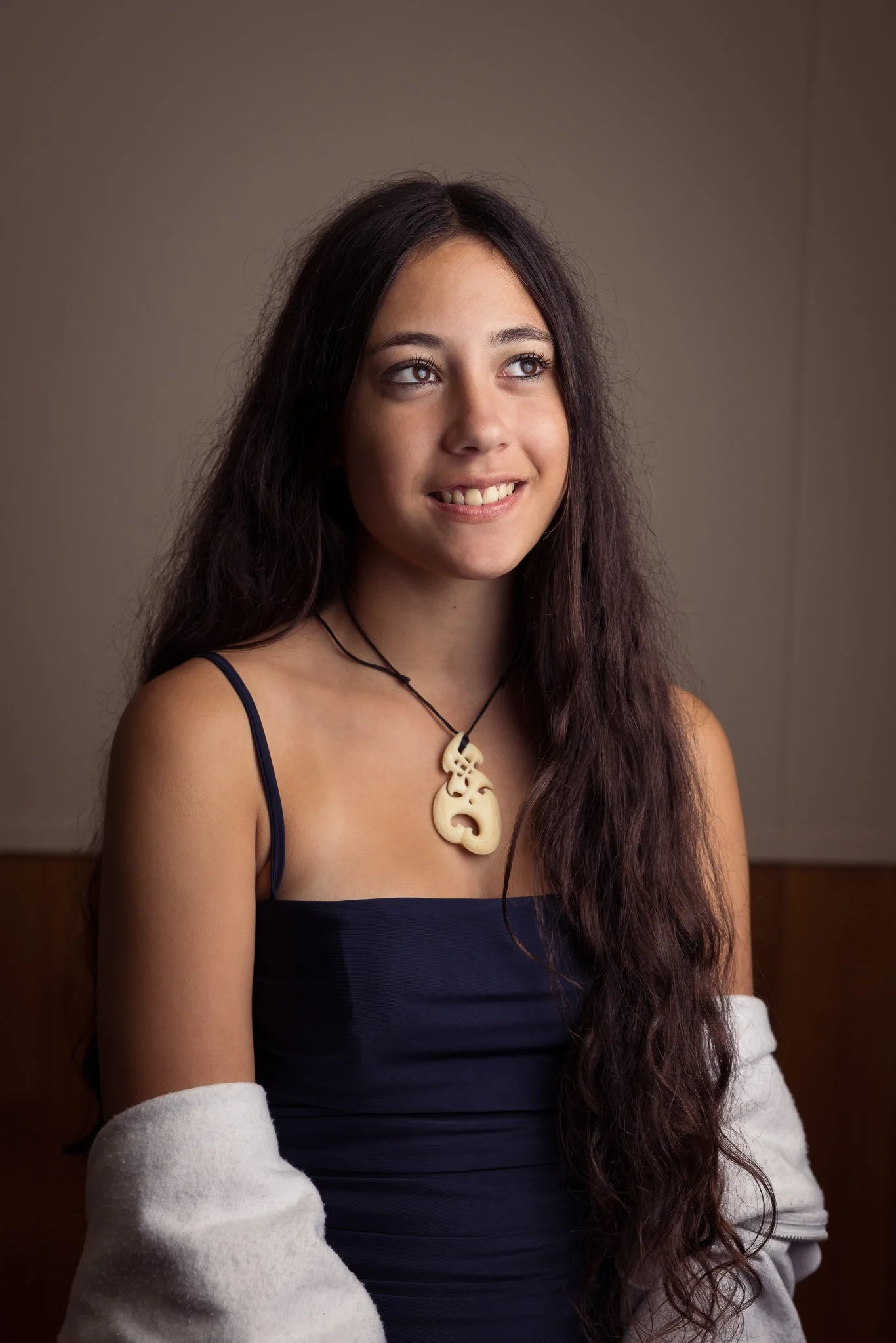A young guest wearing a pounamu pendant for a portrait