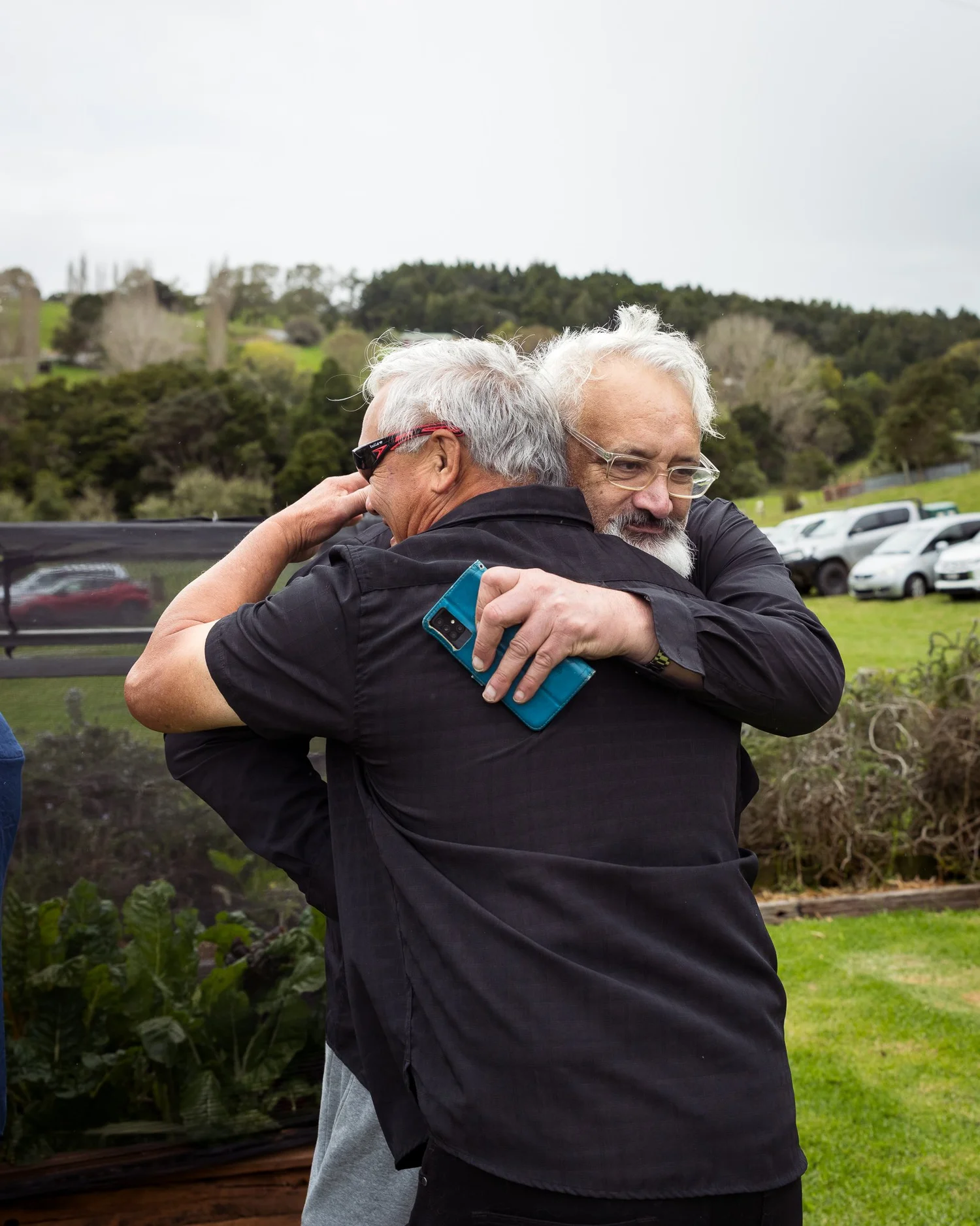 Two guests share a hug after the ceremony