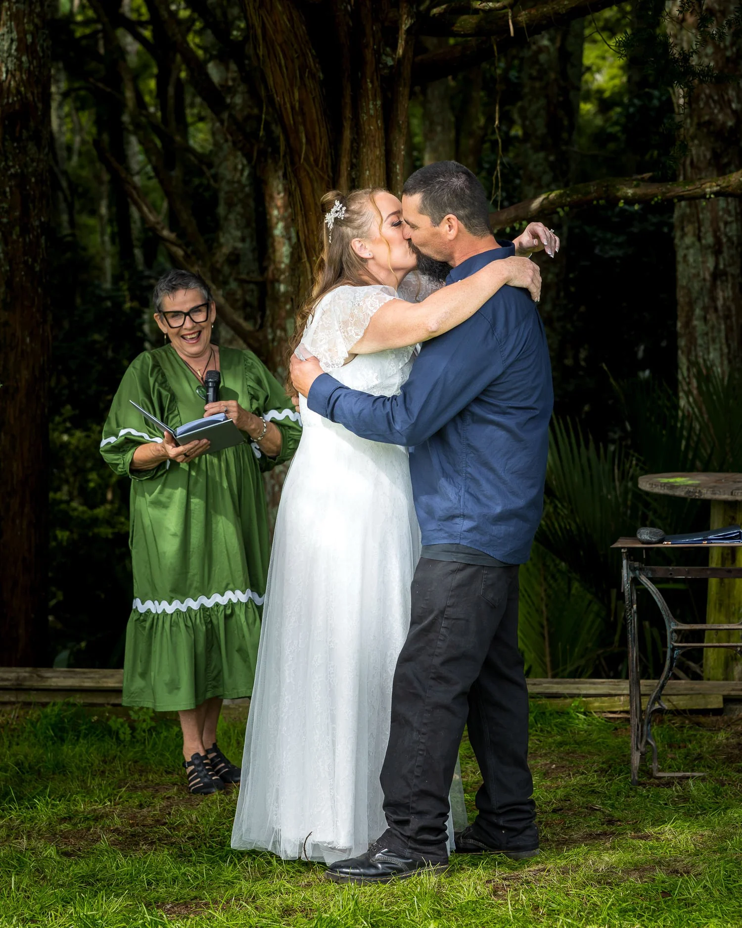 Julia and Alistair kiss beside the celebrant