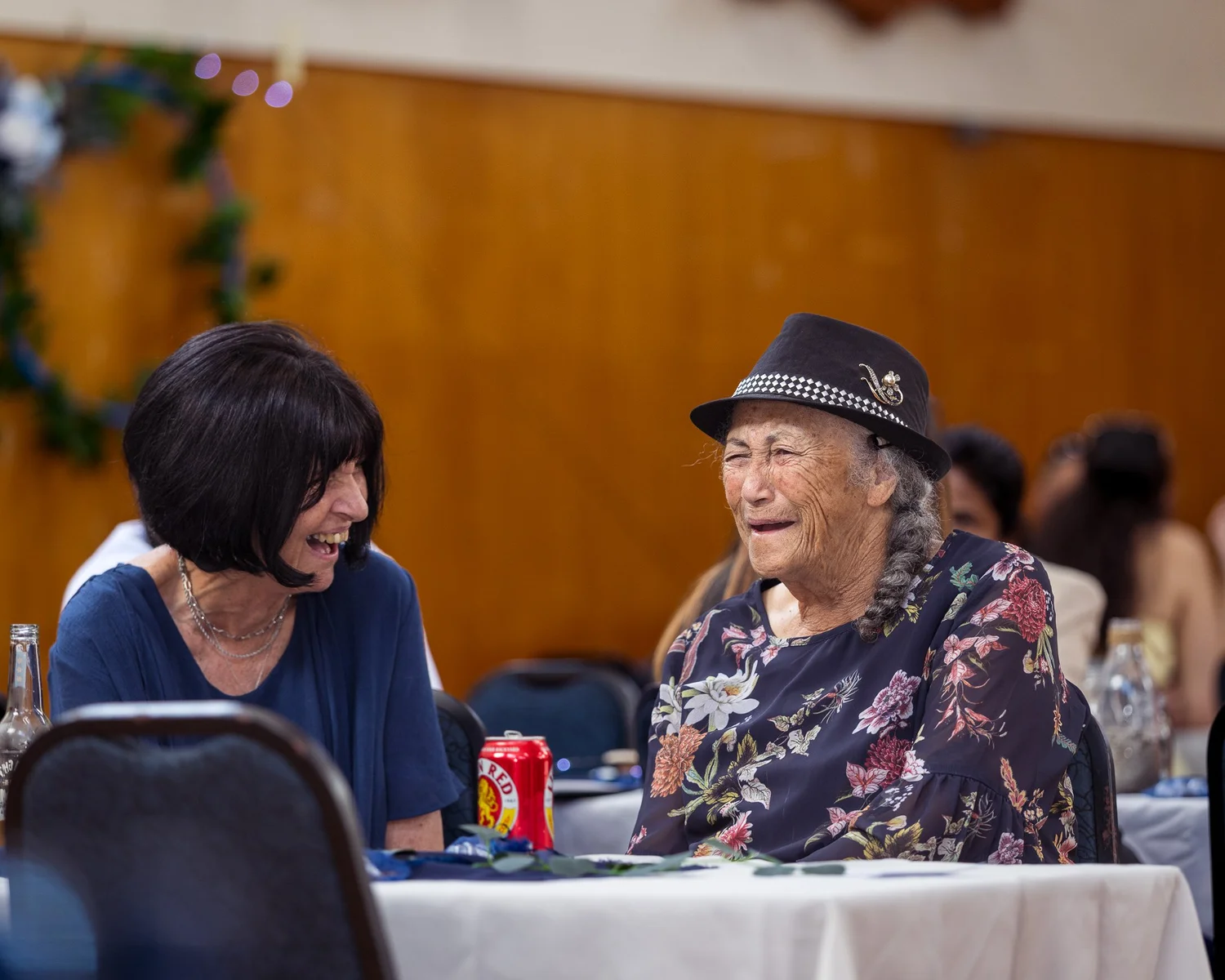 Two guests share a laugh at the reception