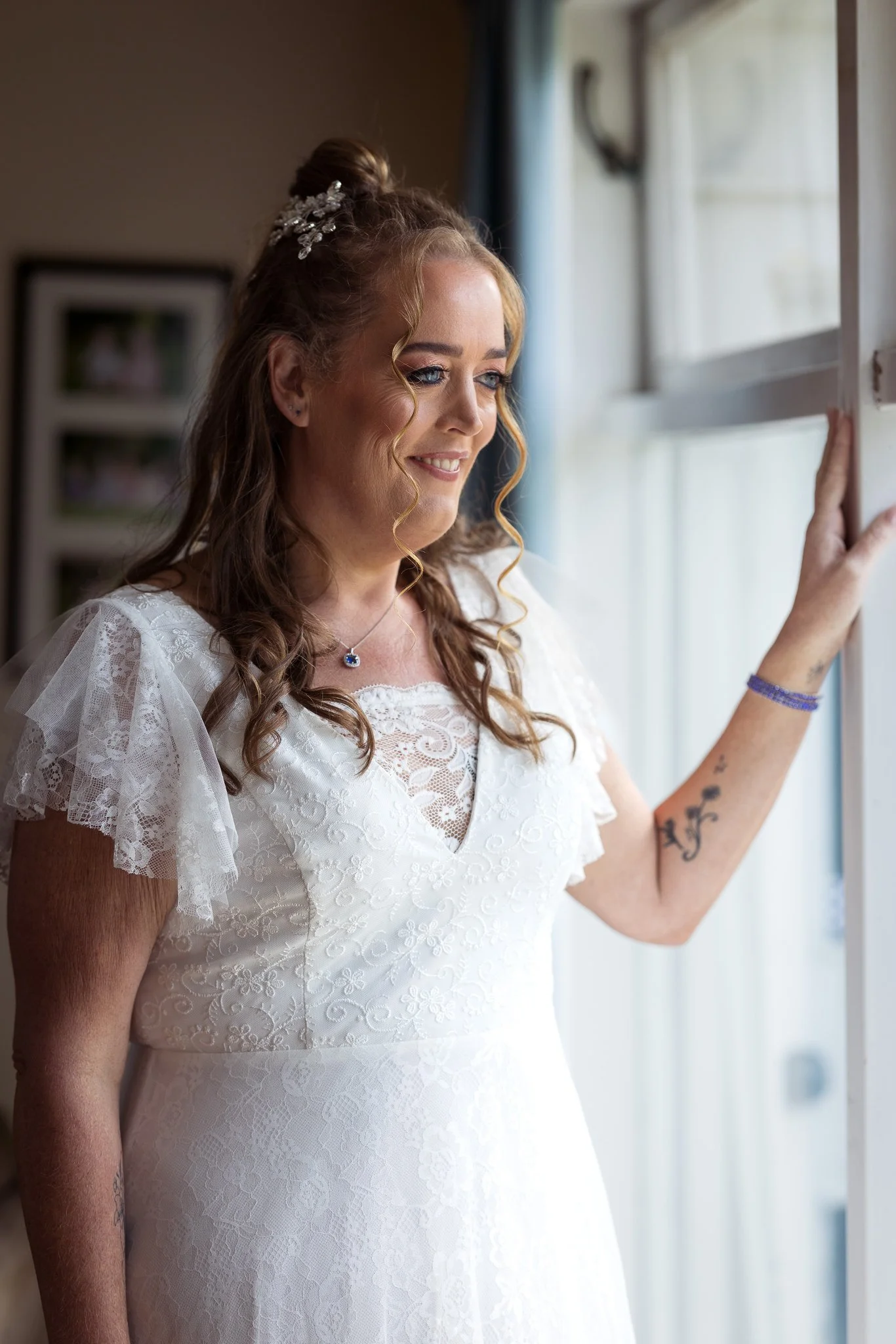 Julia looks out of the window in her wedding dress