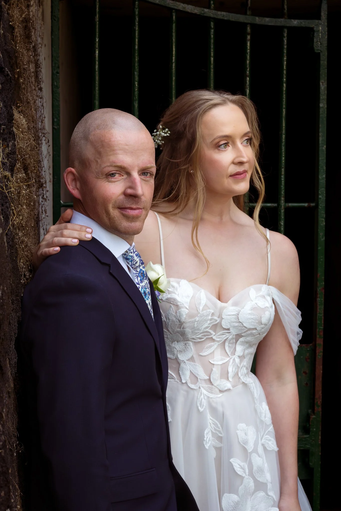 Scott and Kayla lean together in an old doorway