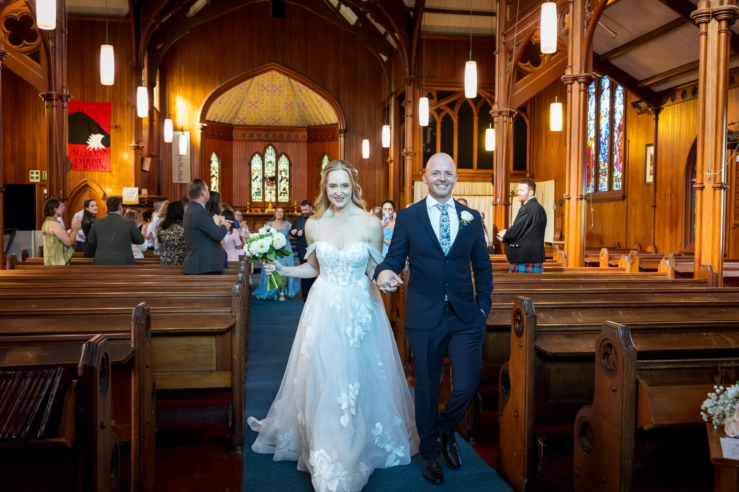 Kayla and Scott walk back down the aisle of the church