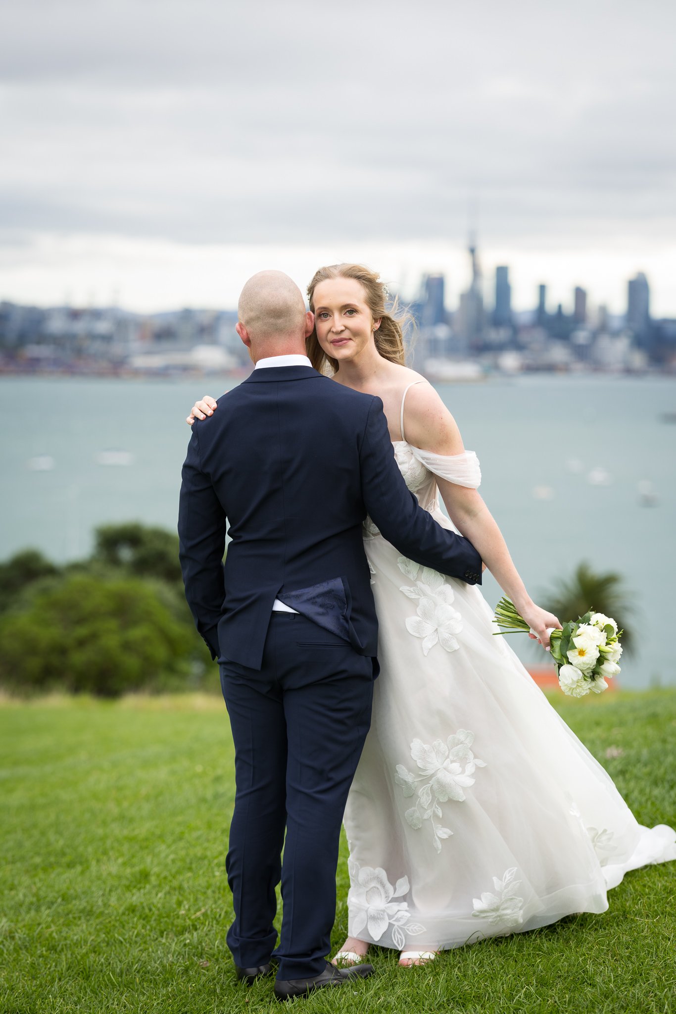 Kayla and Scott with the Auckland city skyline behind them
