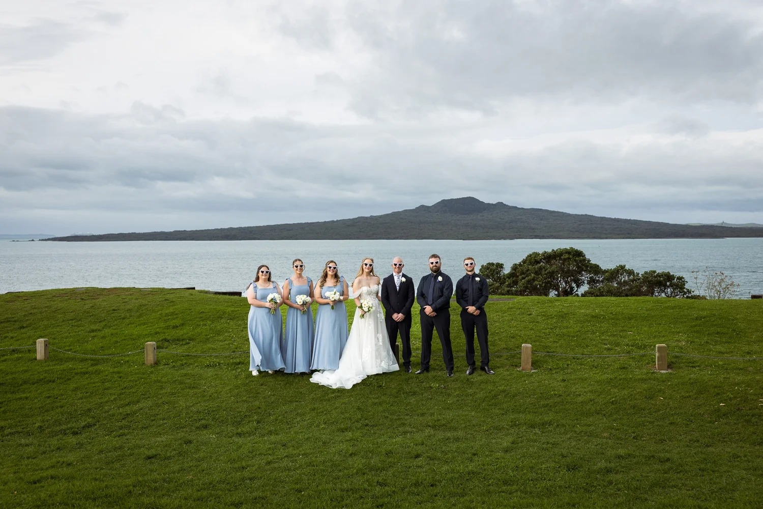 The bridal party on a Devonport clifftop with Rangitoto behind