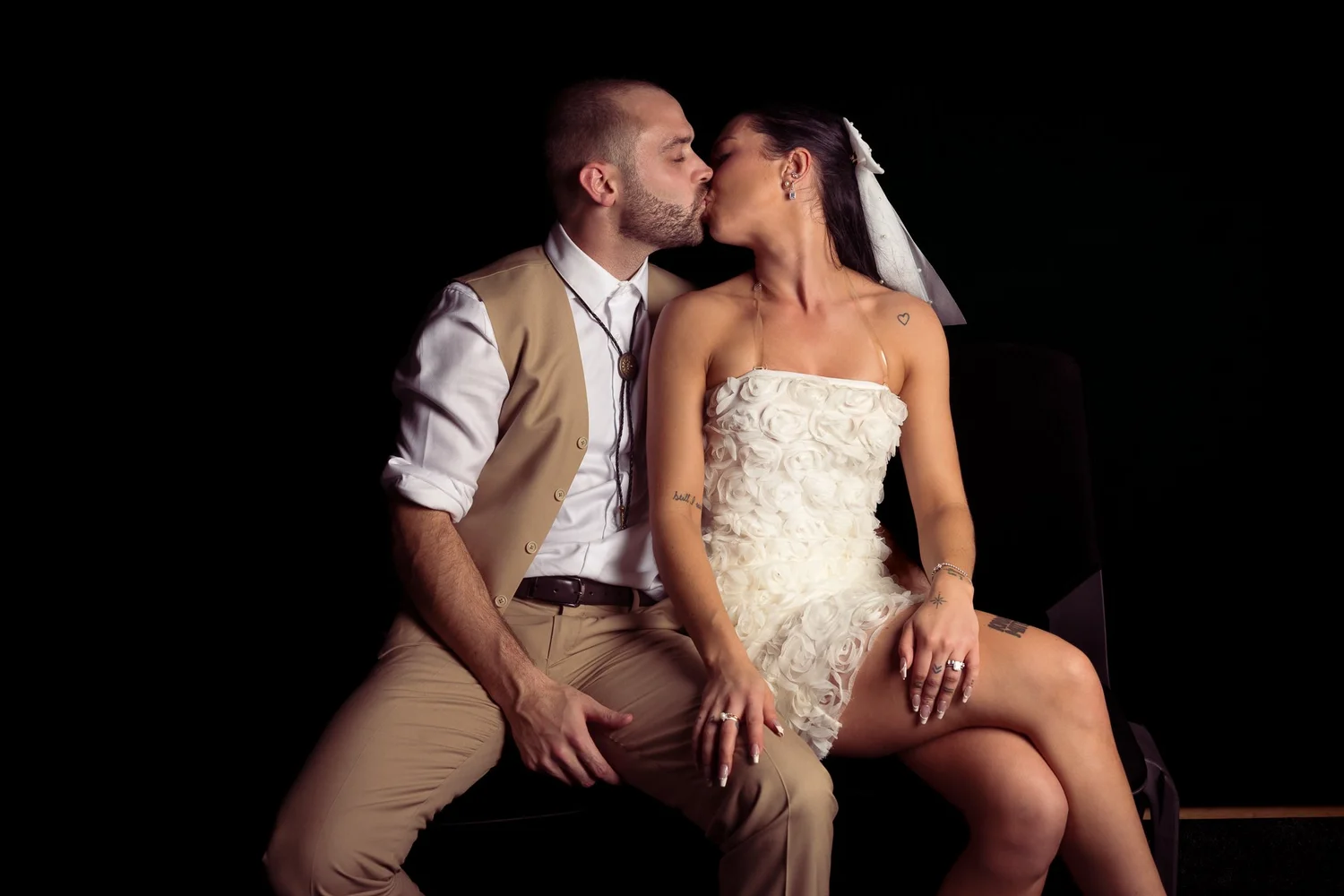 Emma and Corey kiss during an evening portrait