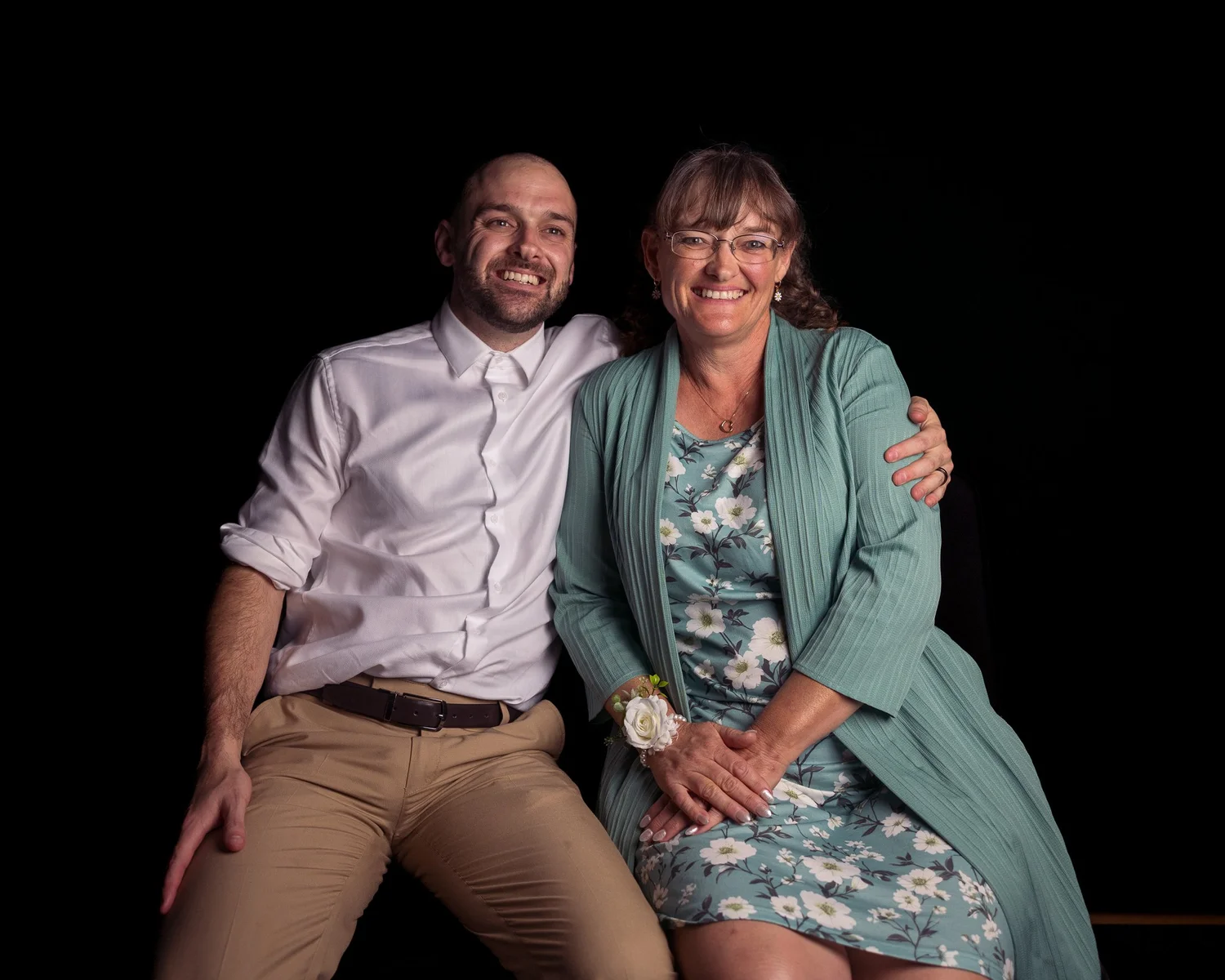 Two guests smile together for an evening portrait