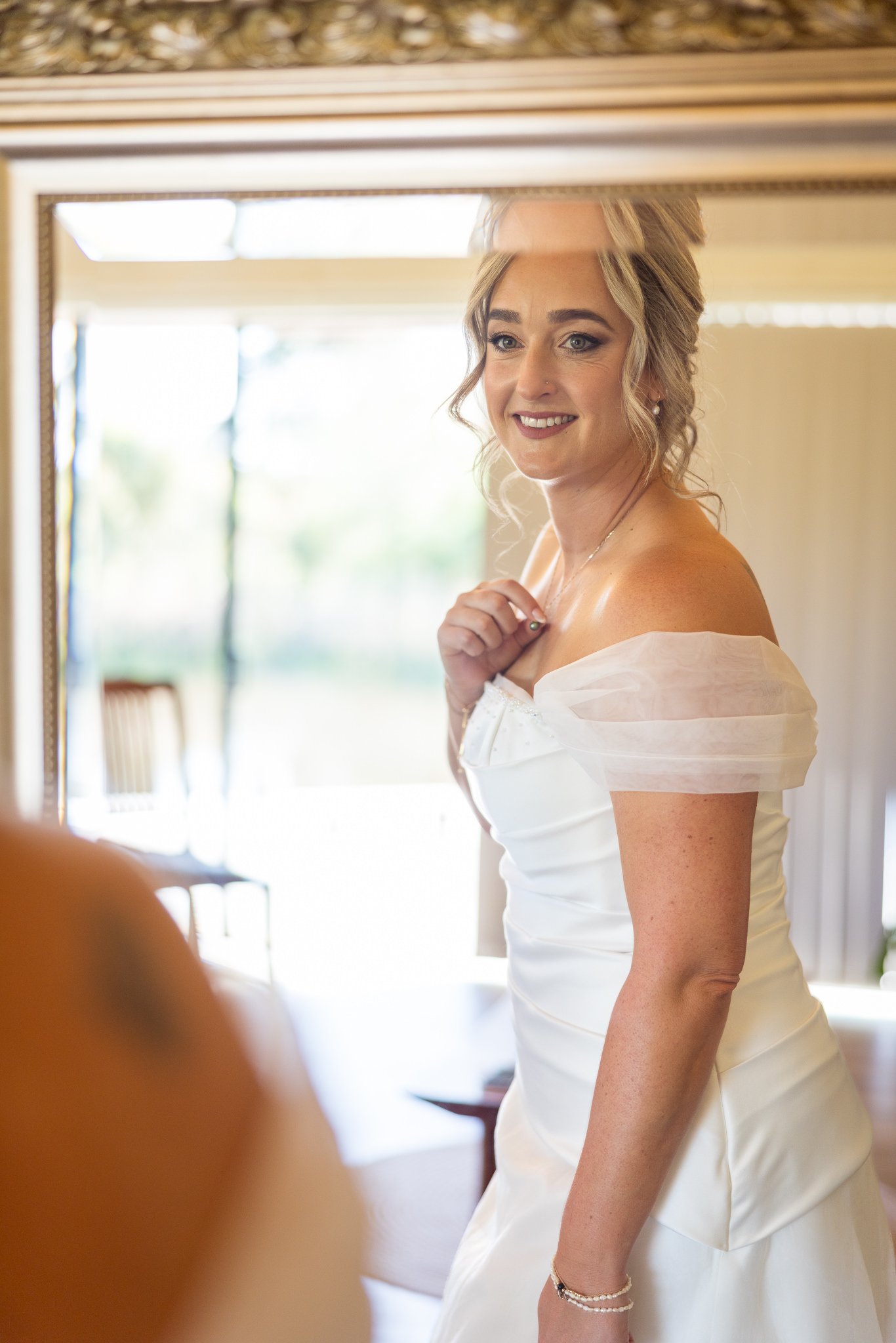 Felicity in her gown standing in a doorway