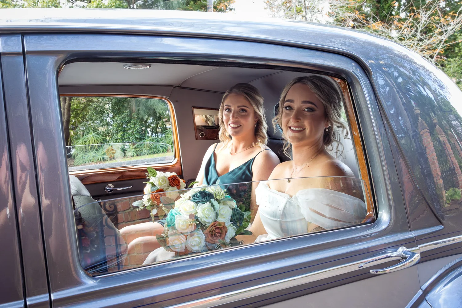 Felicity and a bridesmaid in a vintage Bentley