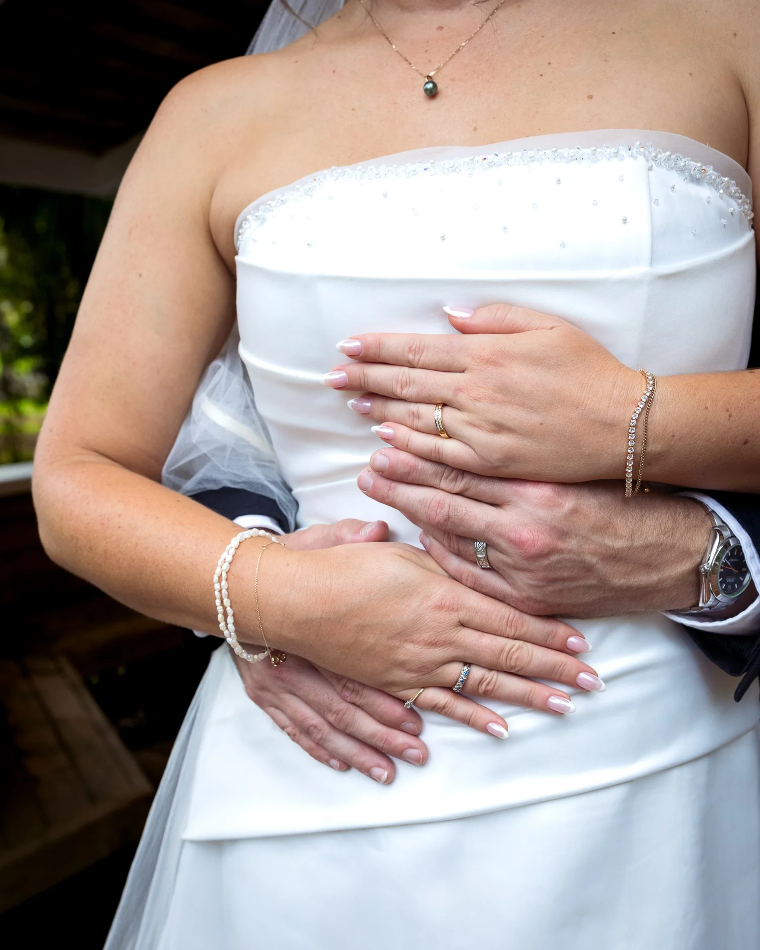 Ronan's hands rest on Felicity's waist, showing their rings
