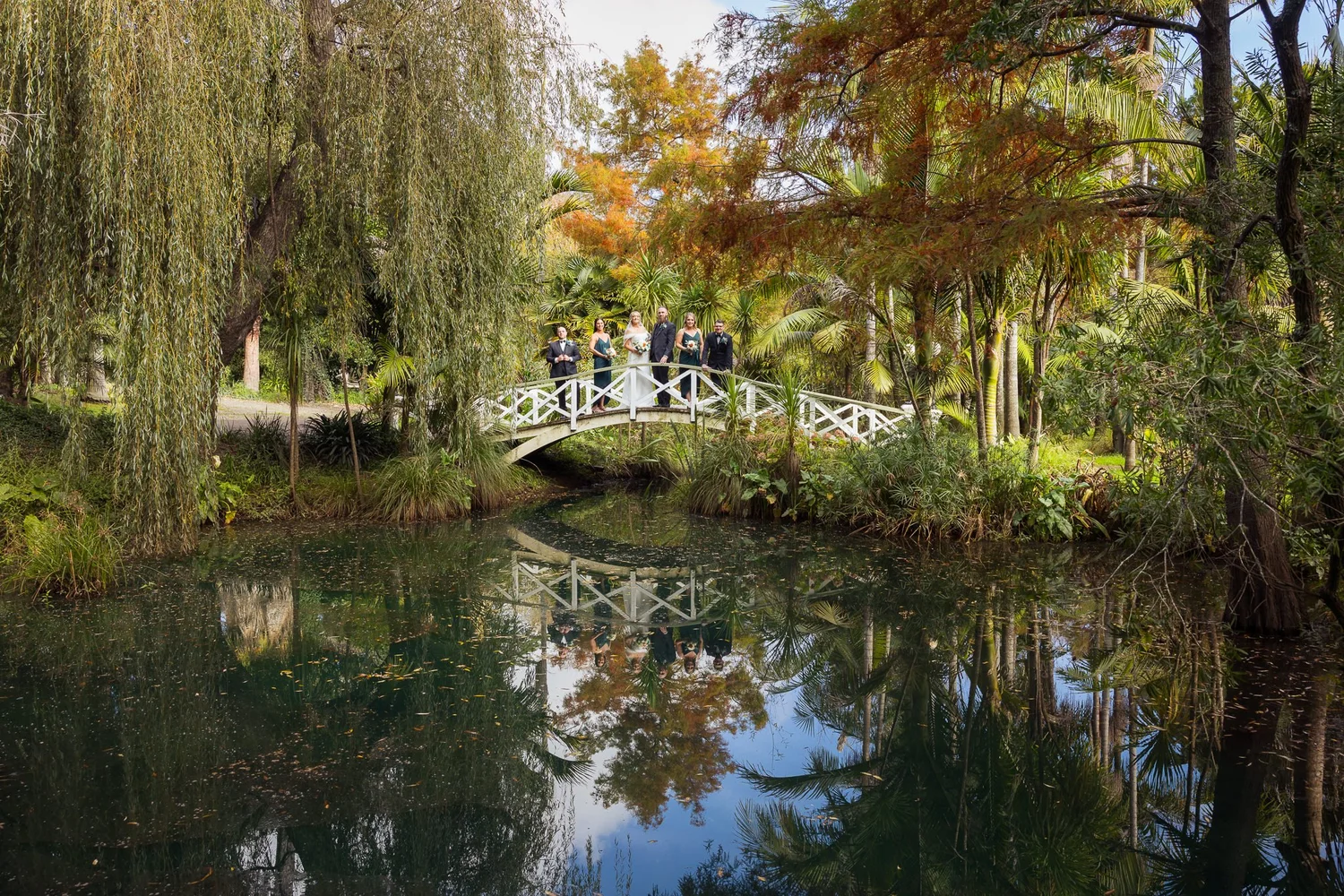 The garden pond and footbridge surrounded by autumn trees