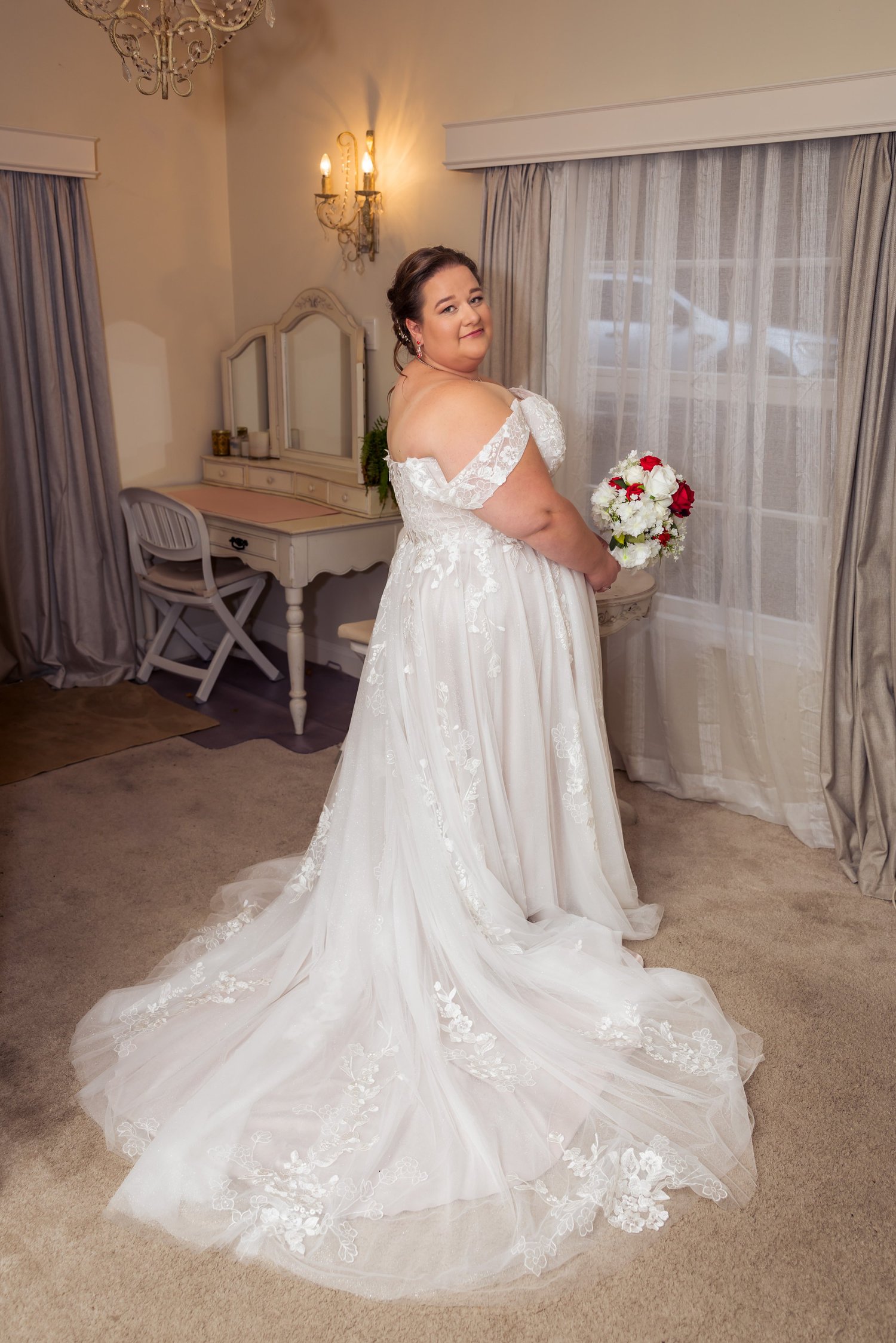 Rebecca in her lace gown in the bridal suite at Bridgewater Estate