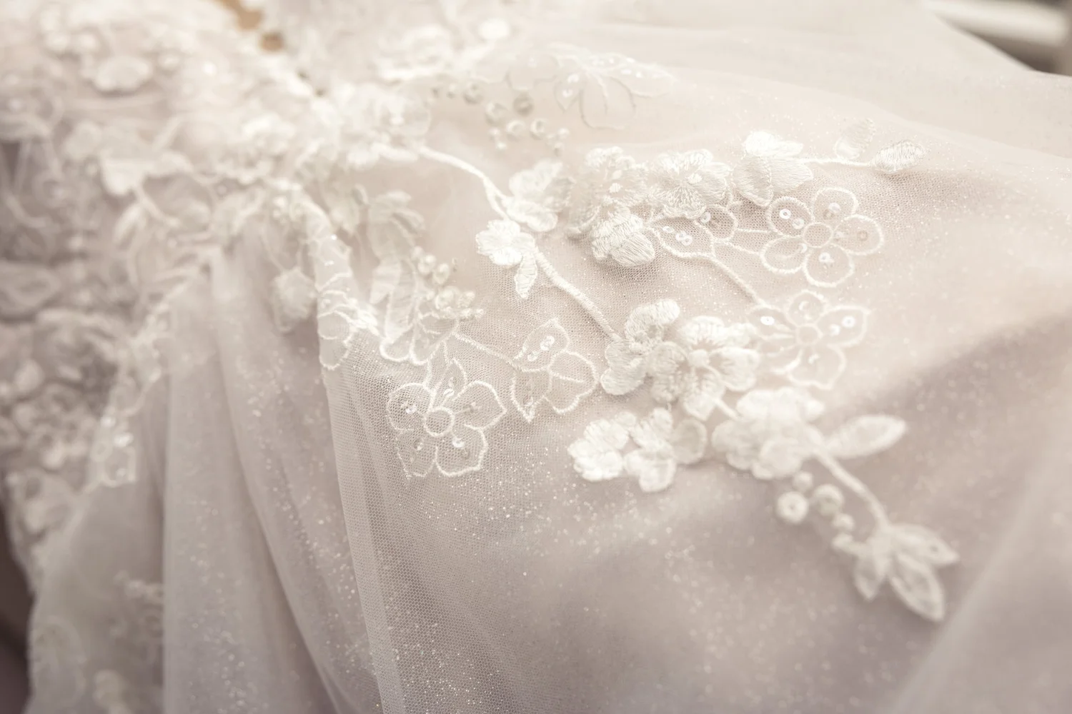 Close-up of the floral lace on Rebecca's gown