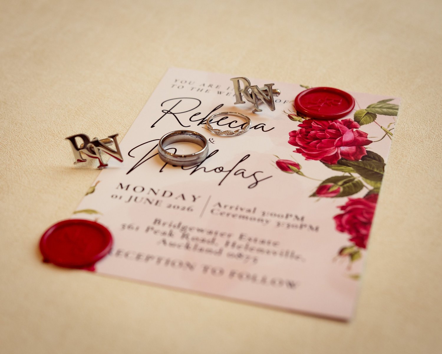 Rebecca and Nick's invitation with red roses and wax seals