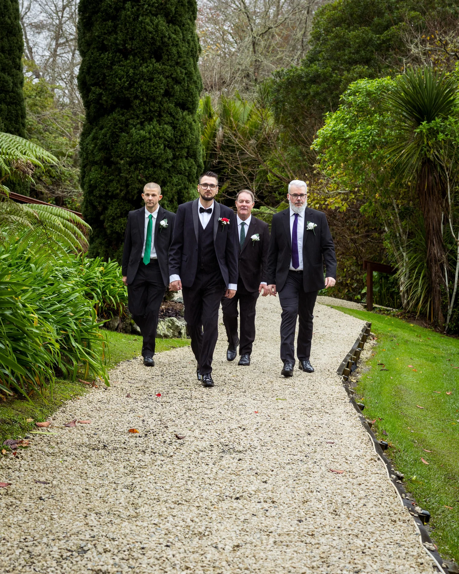 Nick and his groomsmen on a garden path