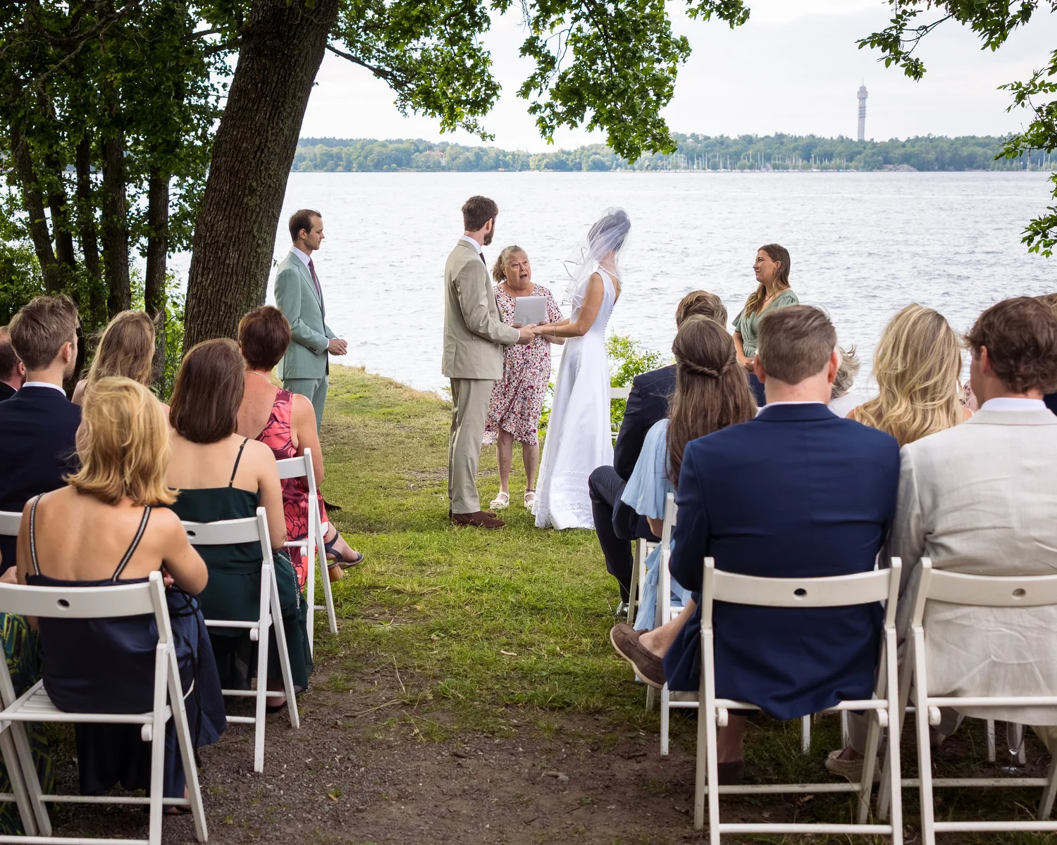 Sofia and John exchange vows on the waterfront under the trees