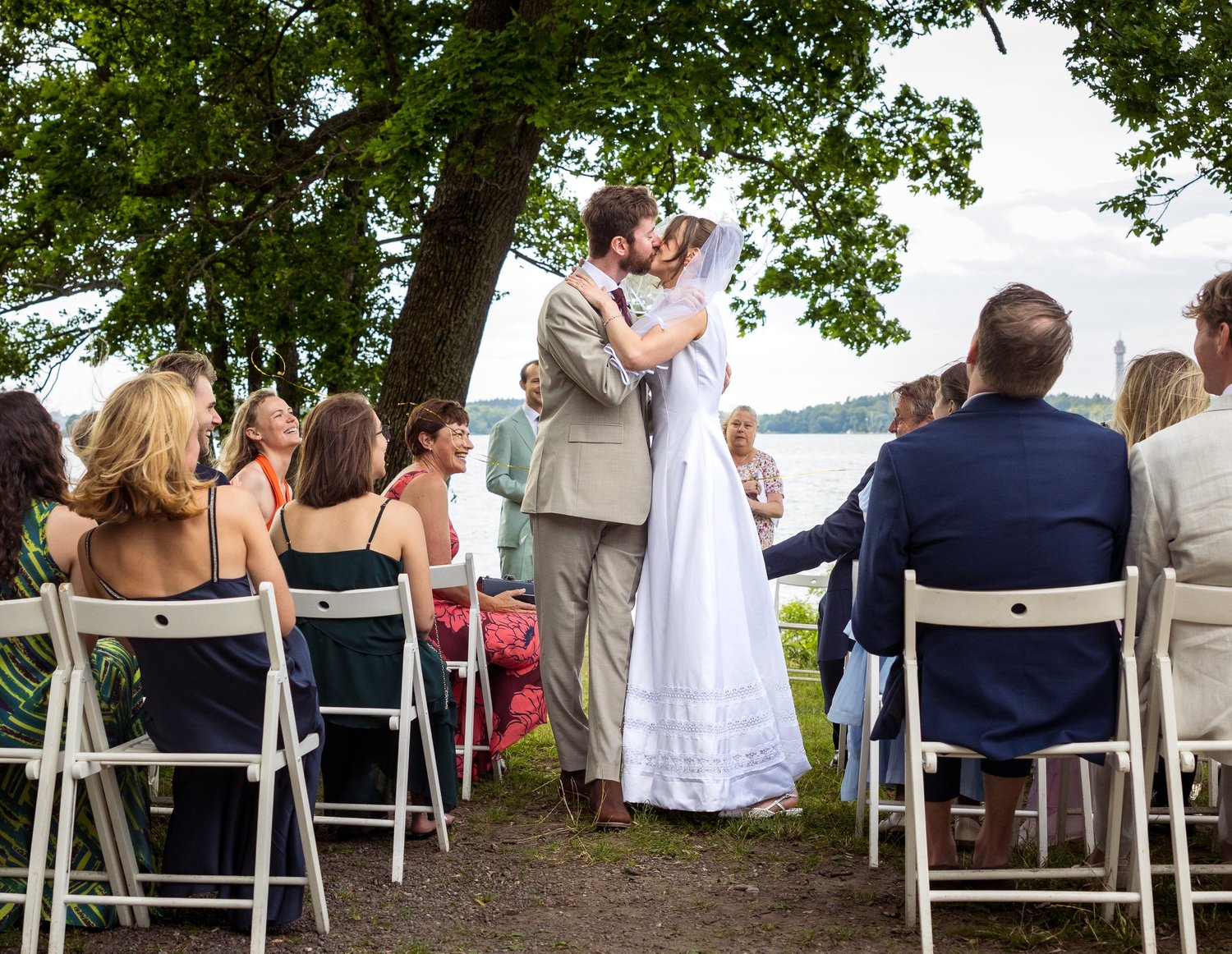 Sofia and John kiss in front of their guests