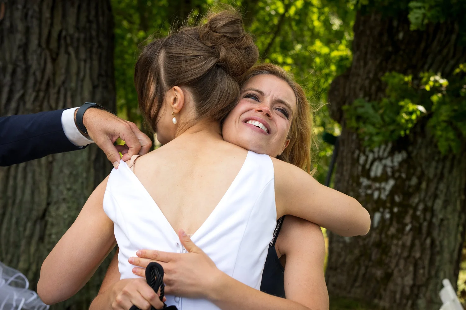 Sofia hugs a laughing guest after the ceremony