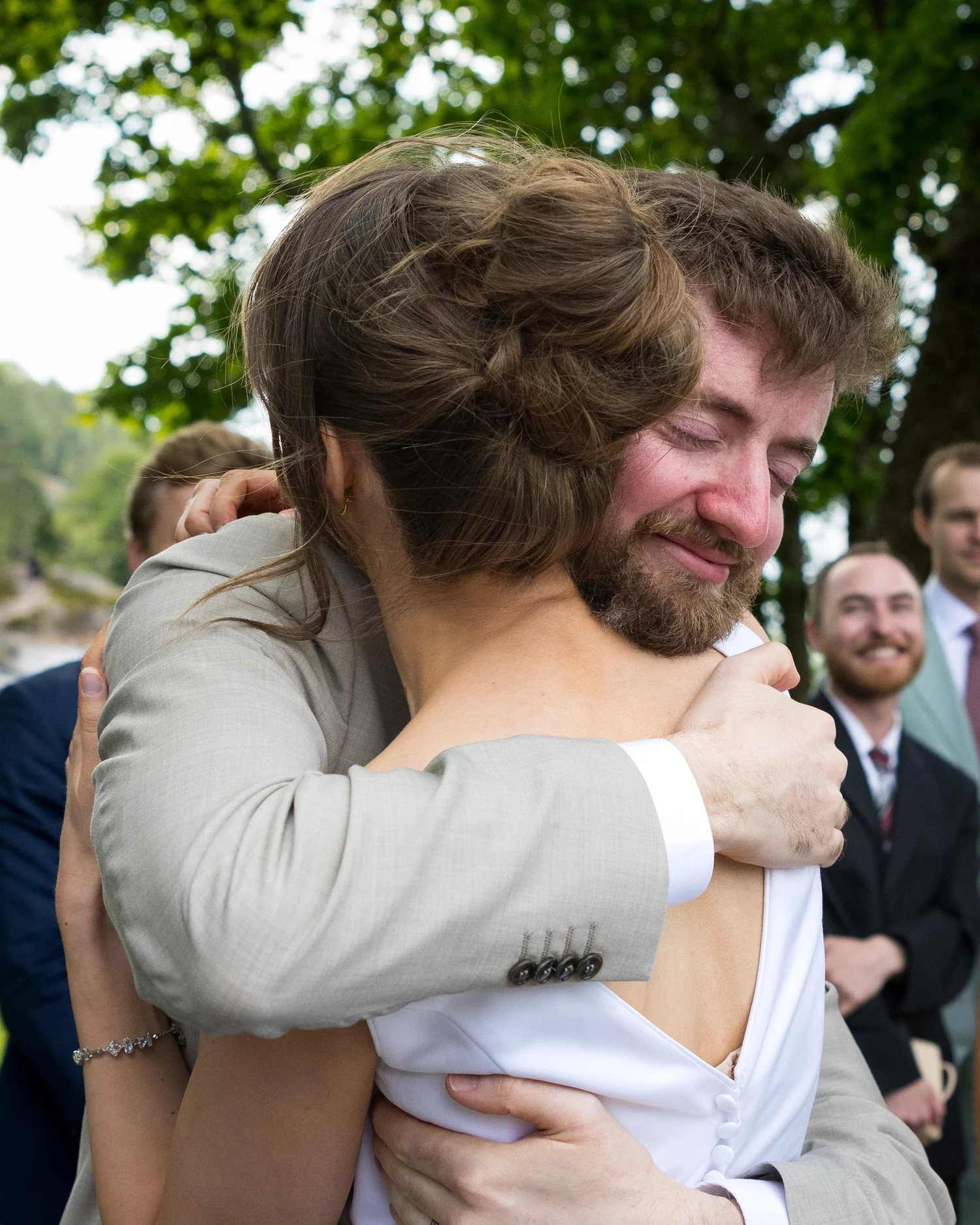 John shares an emotional hug after the ceremony