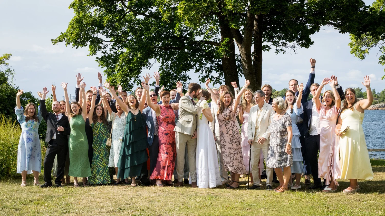 Guests cheer with arms raised for the group photo