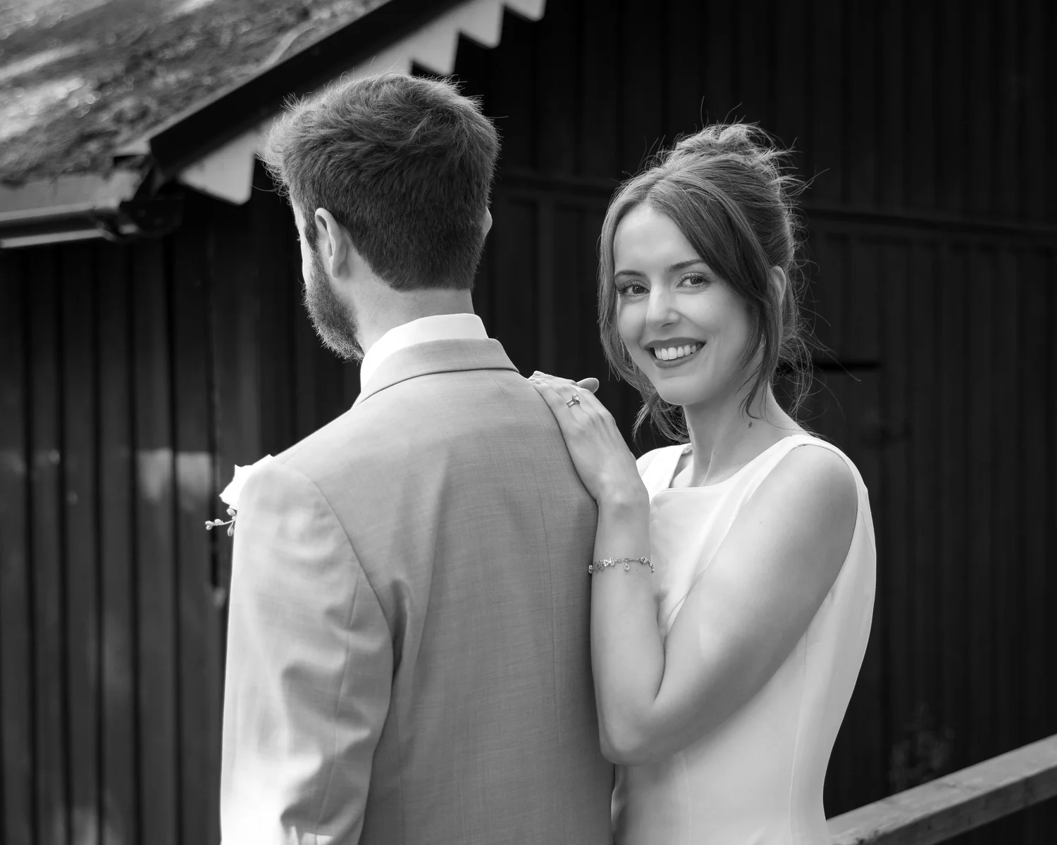 Black and white photo of Sofia smiling over John's shoulder