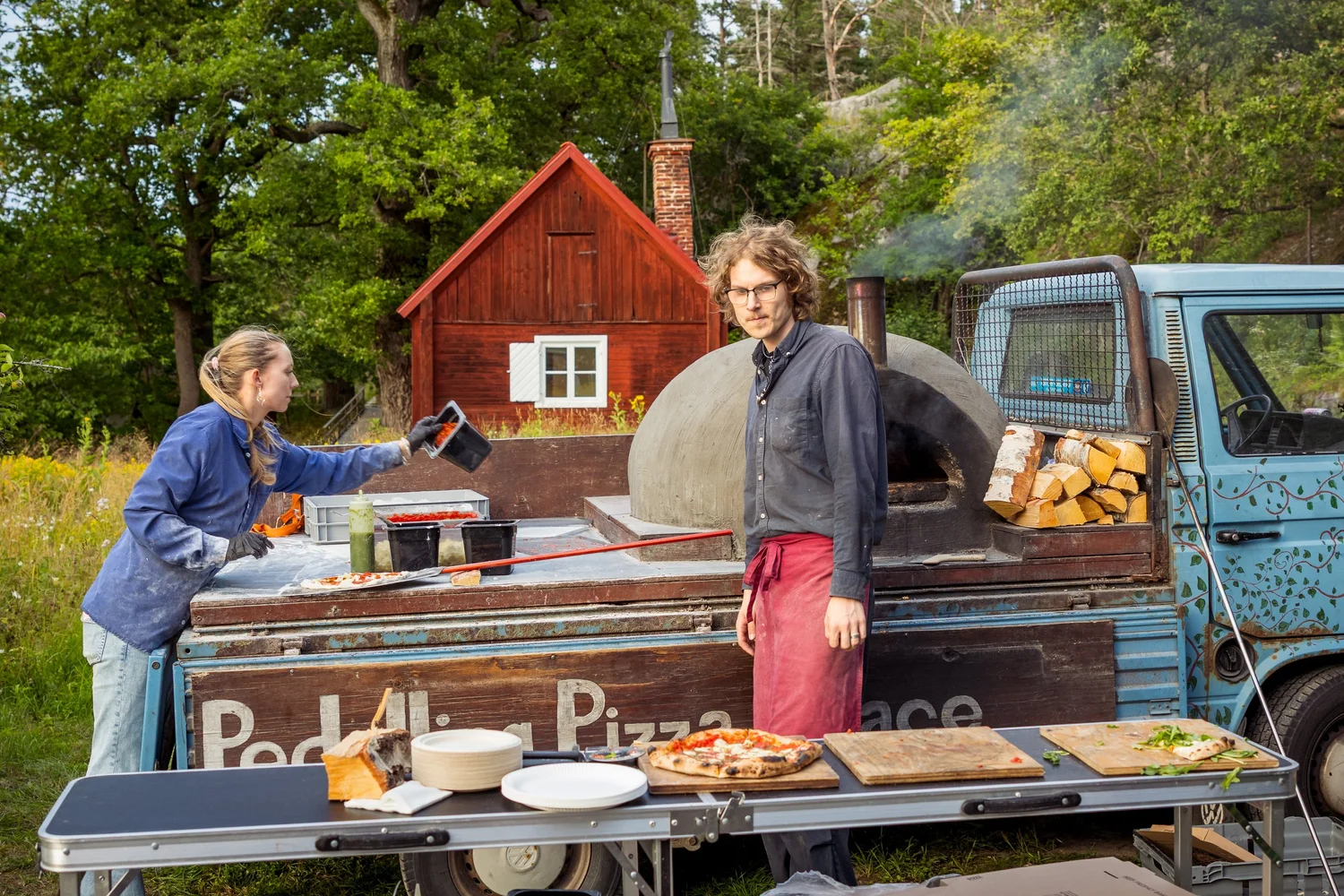 A wood-fired pizza van serving guests in the garden