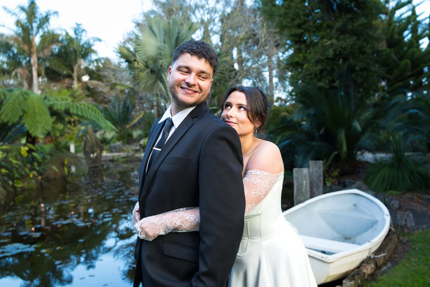 The groom smiles as the bride rests her head on his shoulder