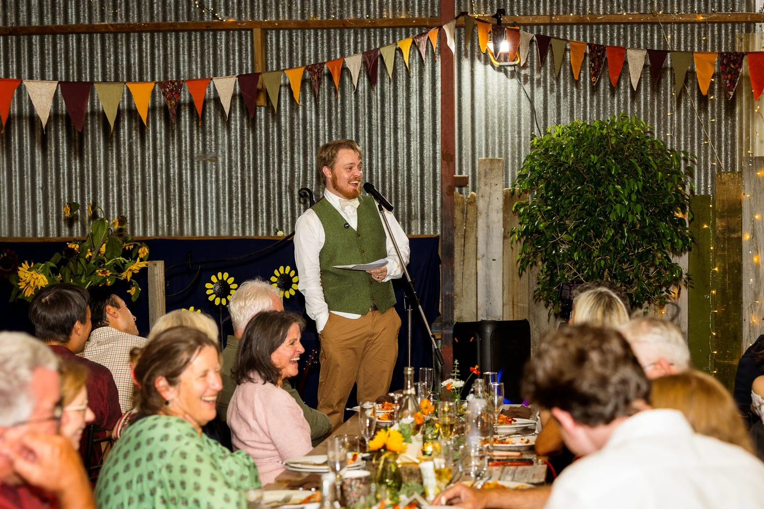 A guest gives a speech under festoon bunting