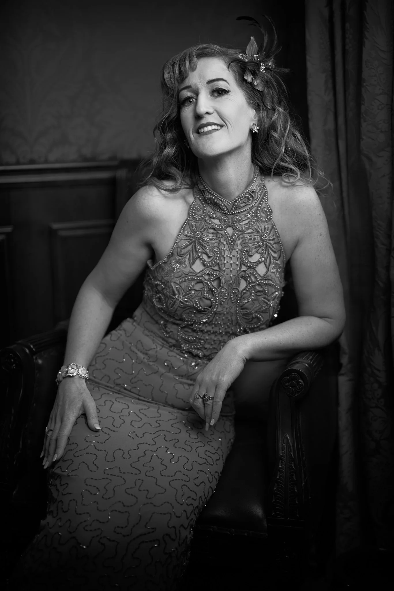 Black and white photo of Sandy seated in a beaded gown