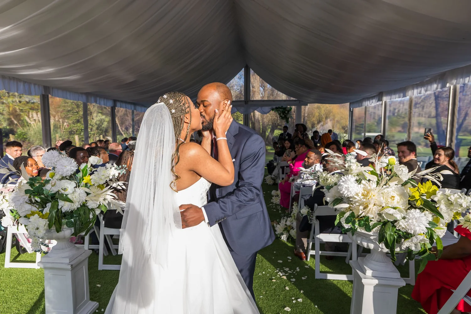 Chiedza and Foster kiss at the end of the aisle