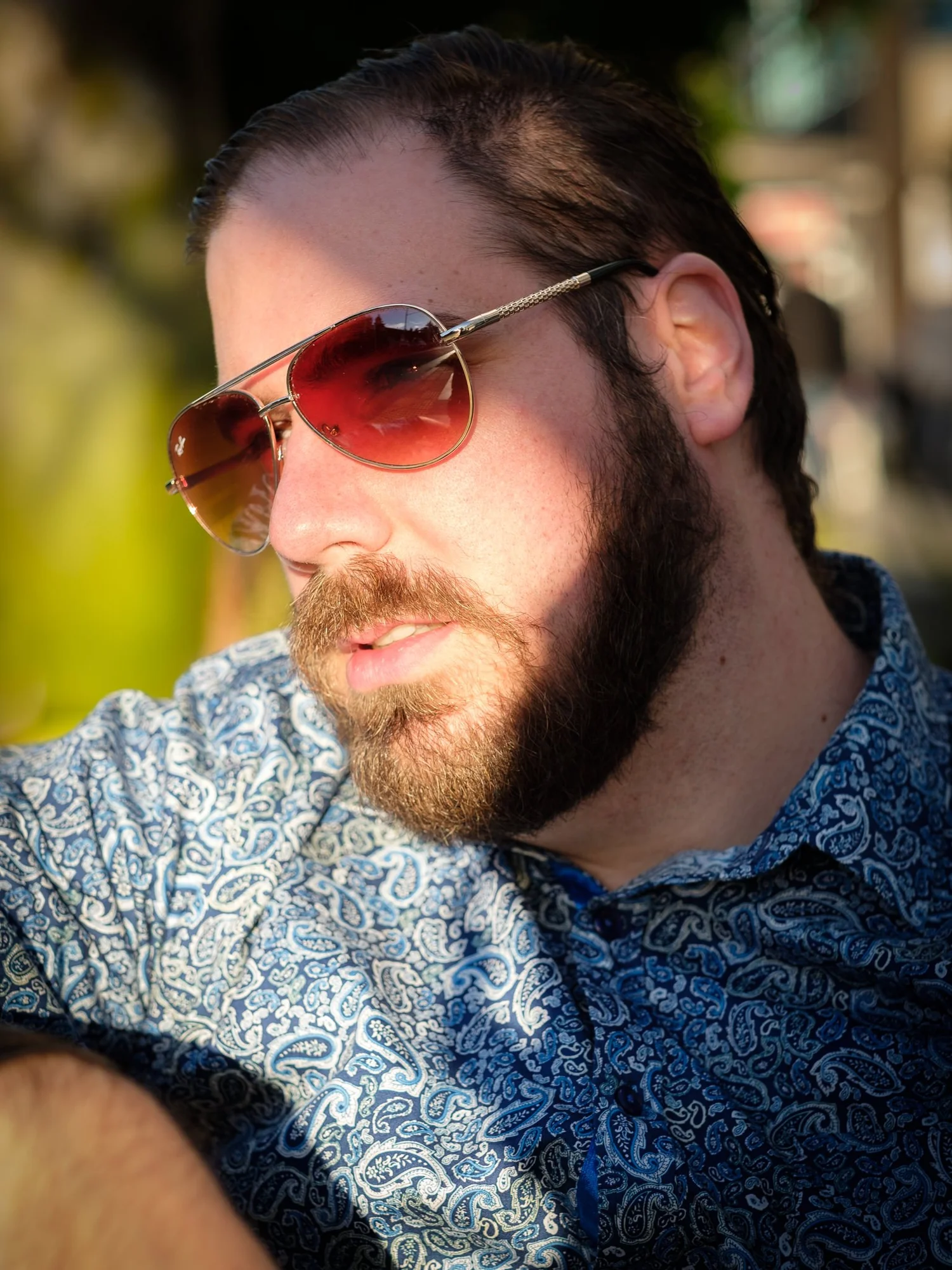 A bearded man in aviator sunglasses