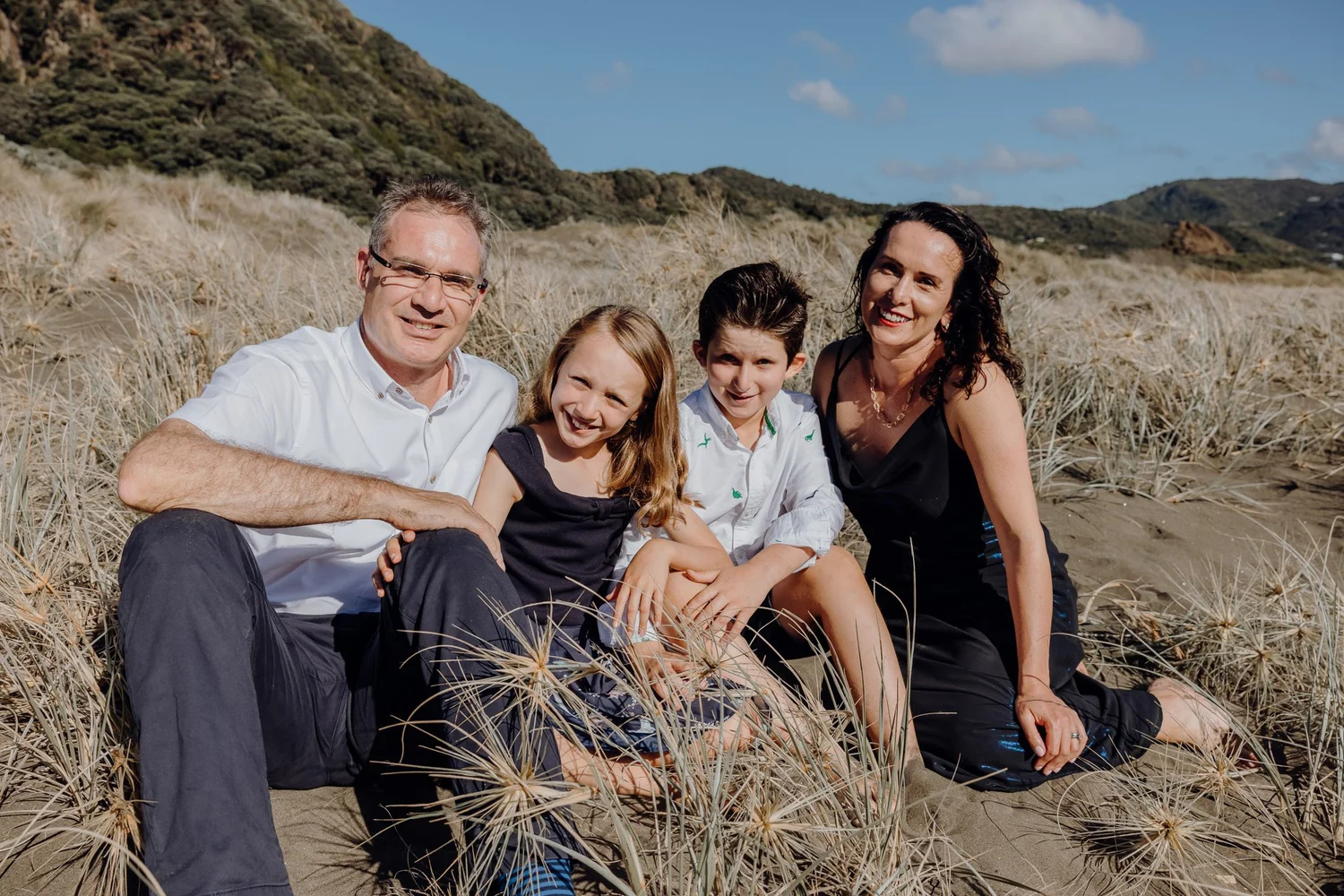 A family sitting together in the dunes