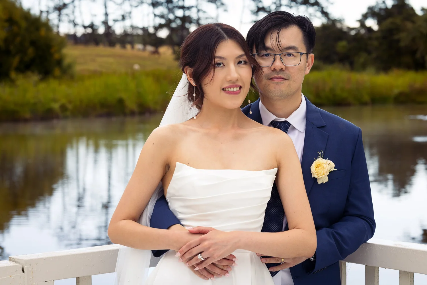 A couple embrace by the lake on the rotunda