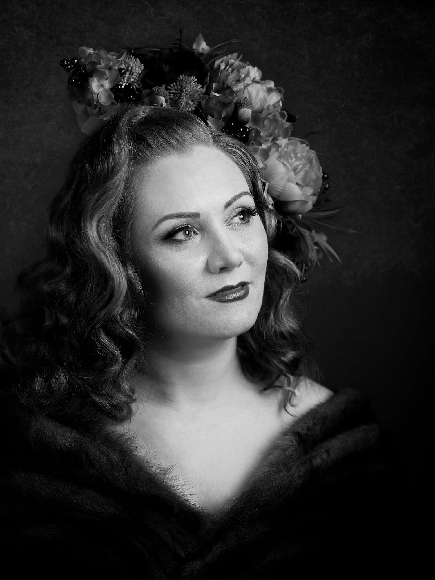 Black and white portrait of a woman with a flower crown