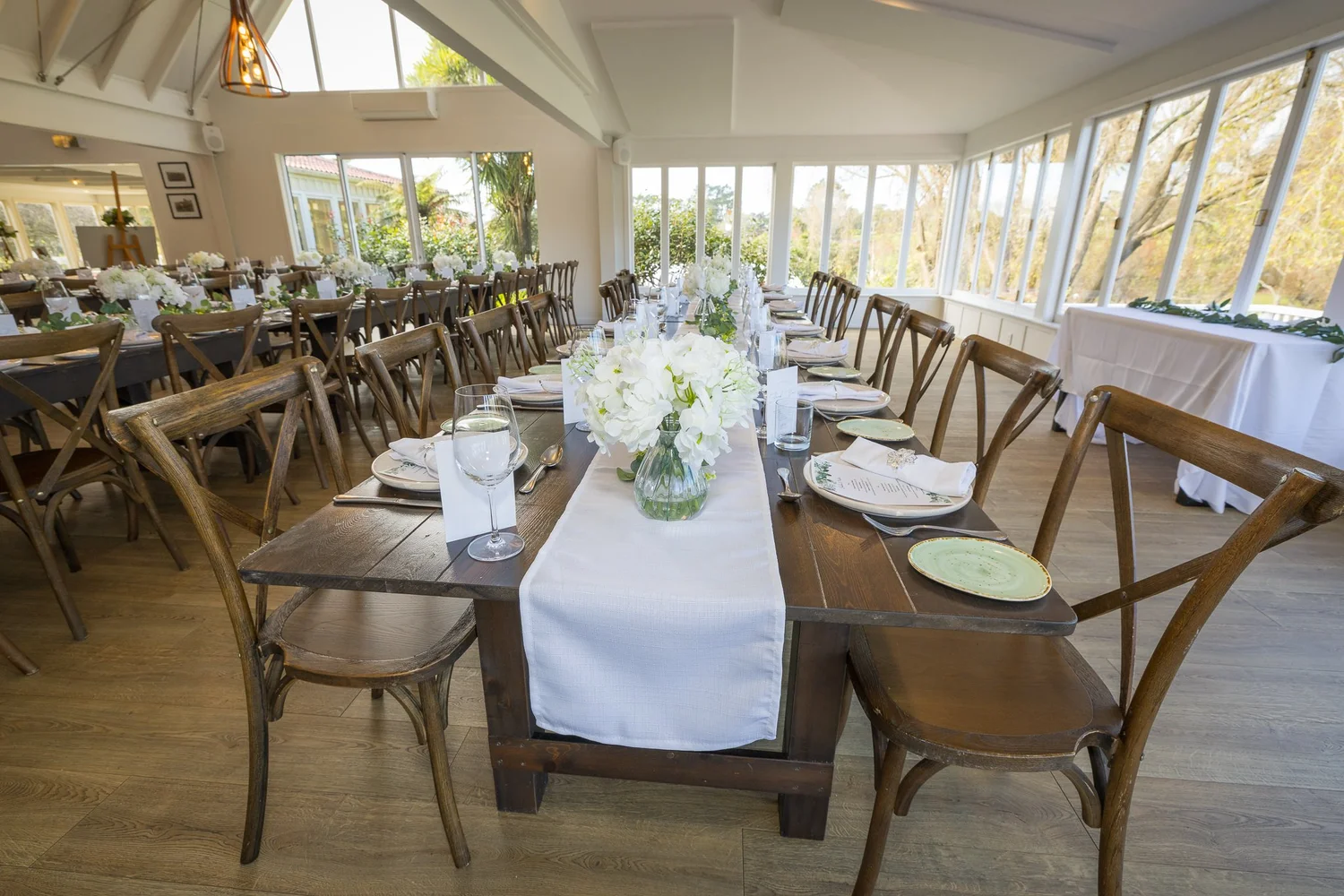 Long reception tables in the light-filled dining room at Abel Estate