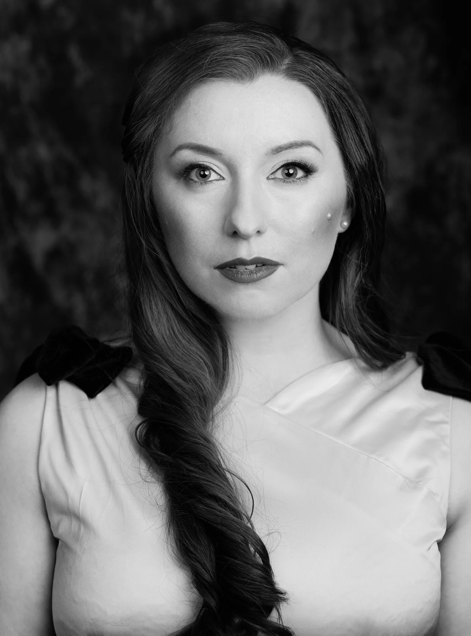 Black and white portrait of a woman with a long side plait