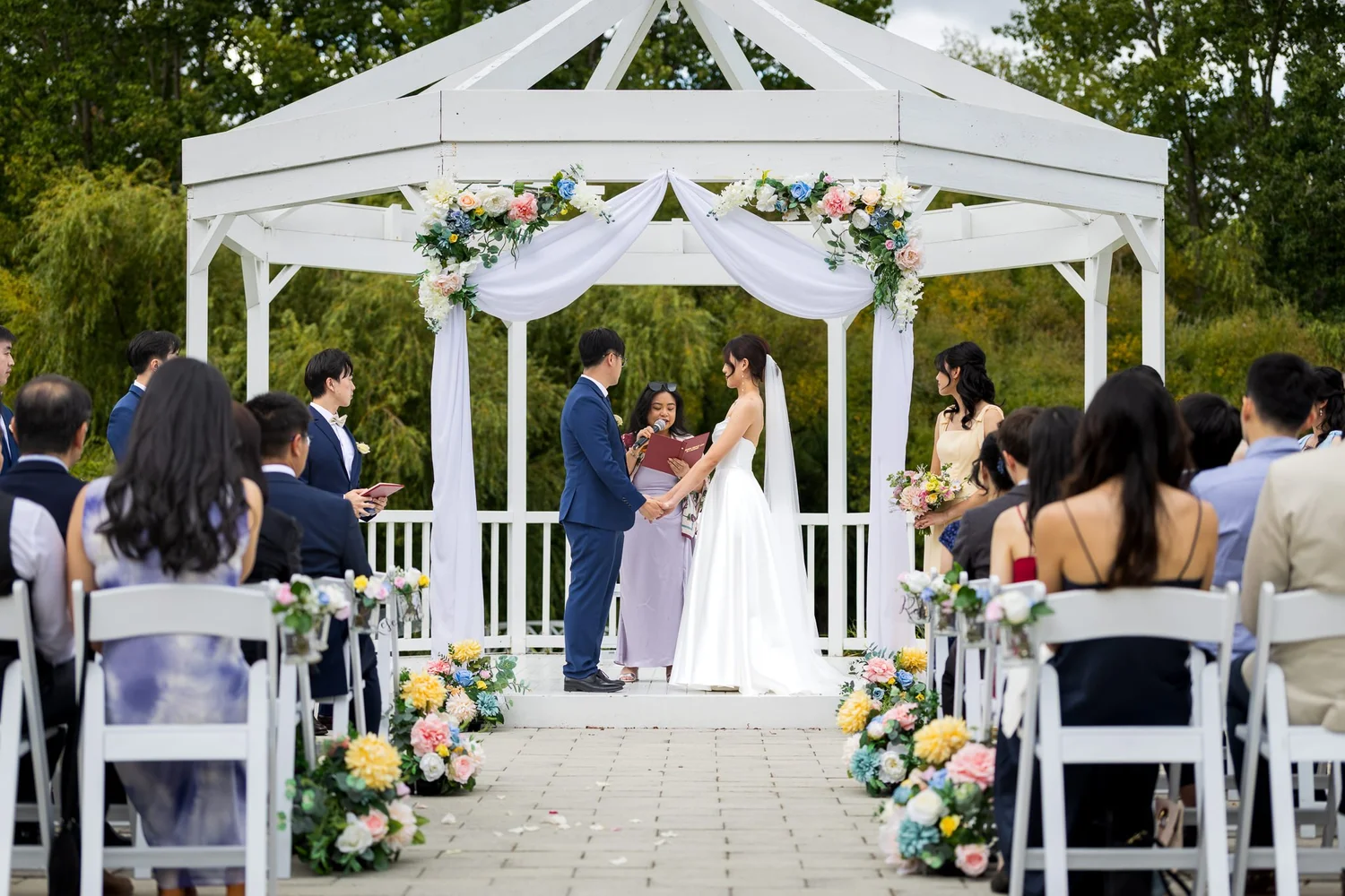 A couple stand together at the gazebo during their ceremony
