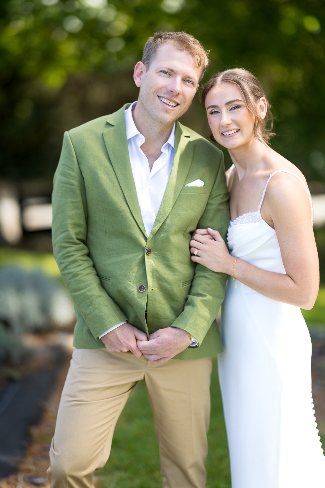 Ben in a green jacket stands with Jade in the garden
